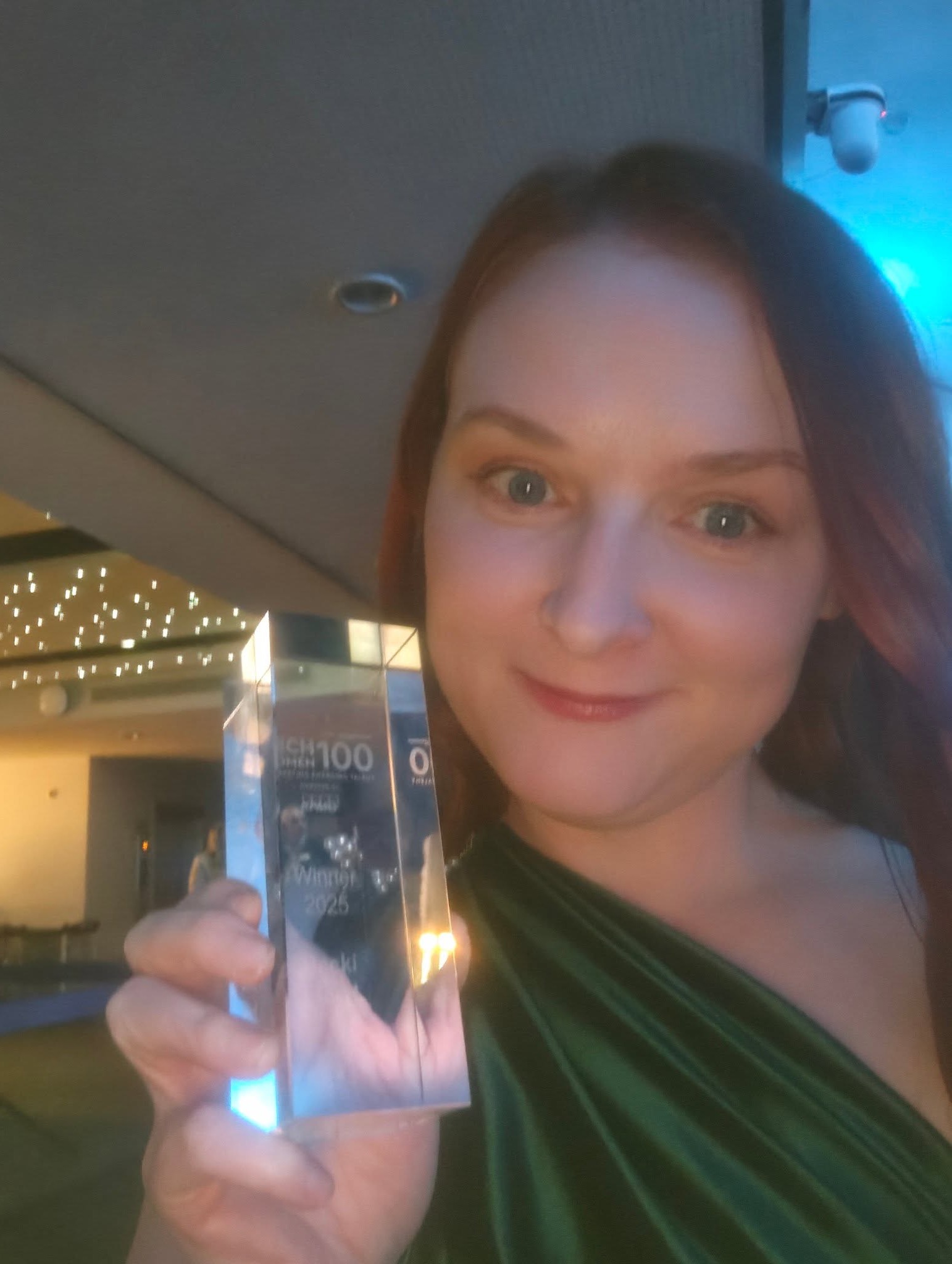 Becki Floyd holding her TechWomen100 2025 award